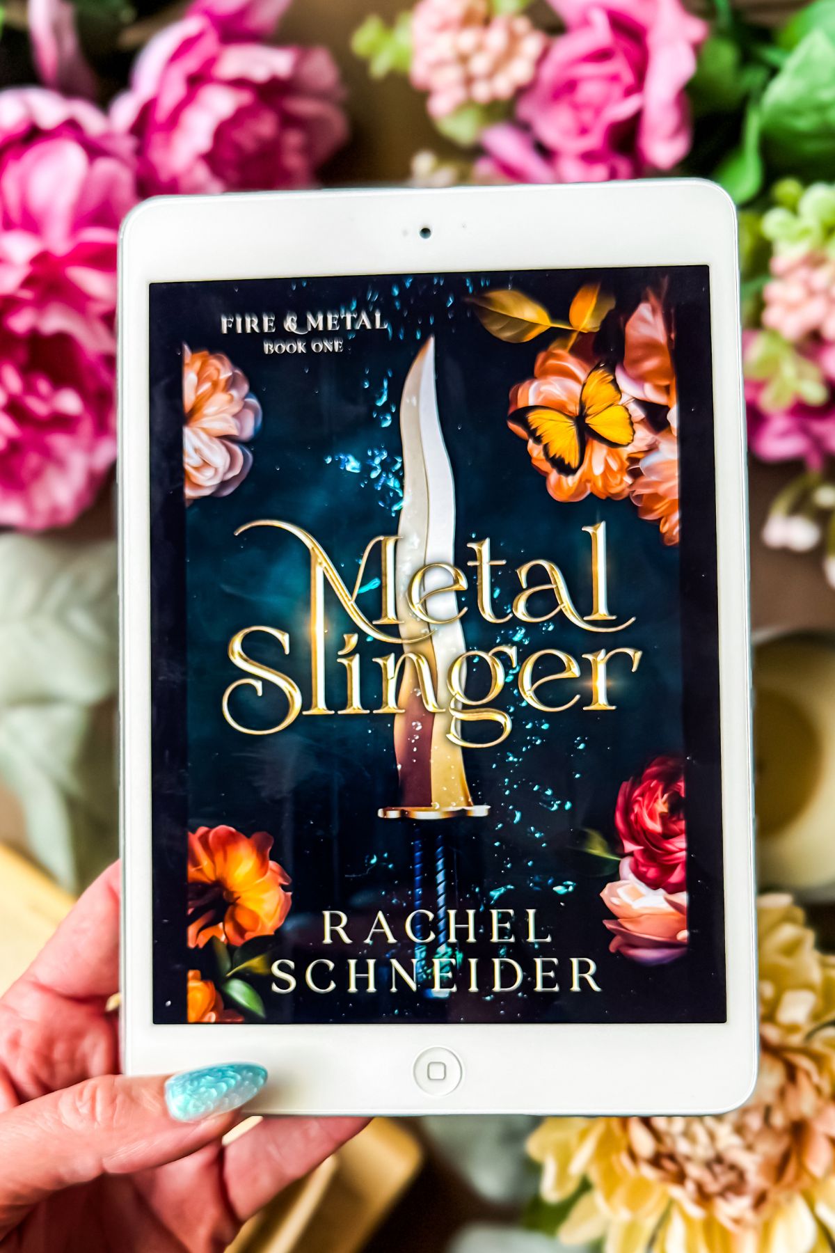 metal slinger book on iPad with flowers and candles.