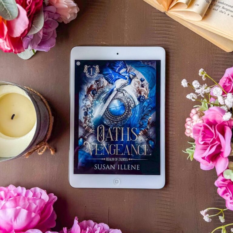 Oaths & Vengeance book on an iPad flat lay with flowers and an open book
