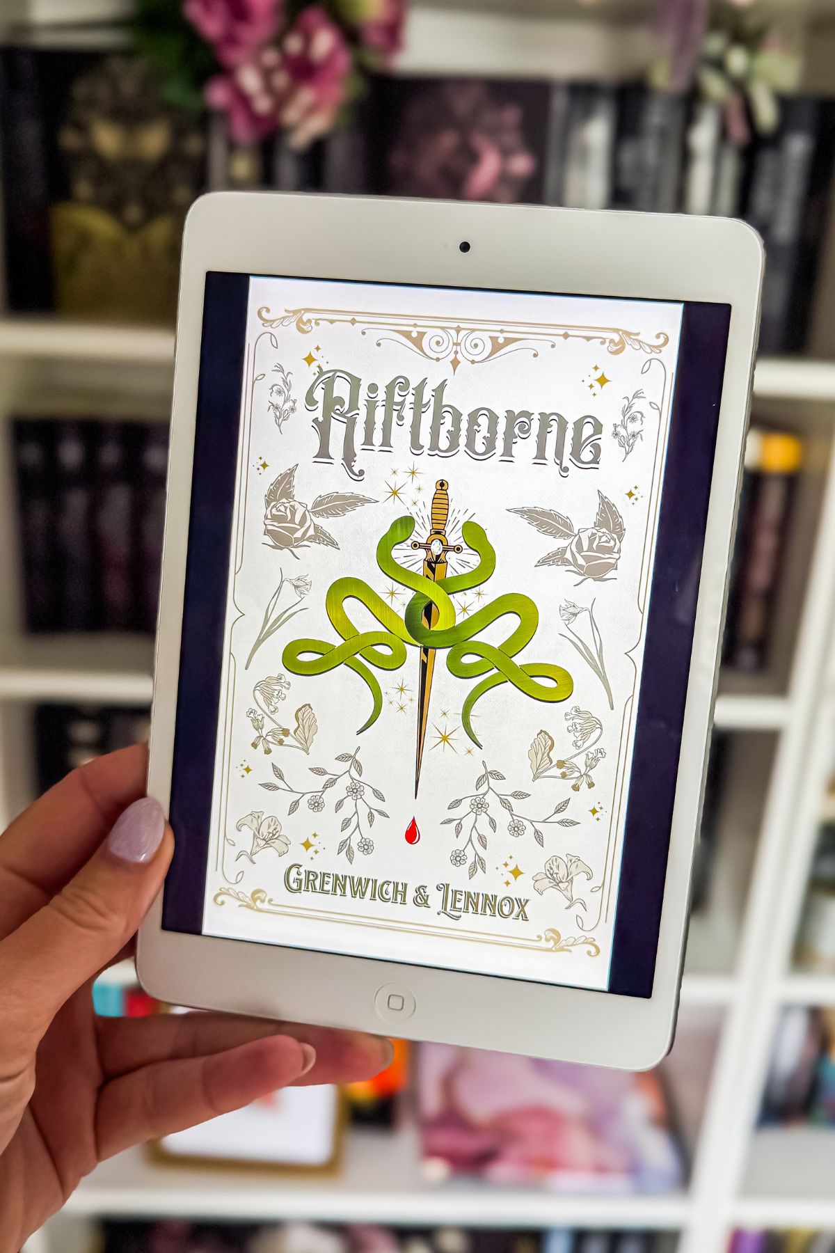 rift borne book on an iPad in front of a bookcase.