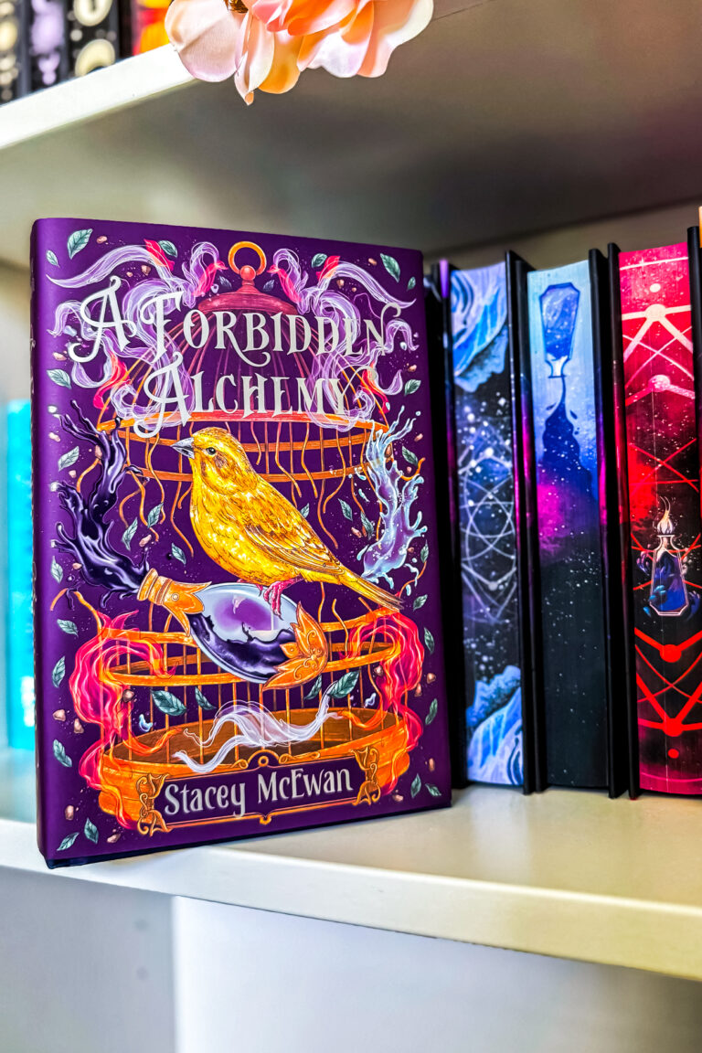 A Forbidden Alchemy books on a book shelf.