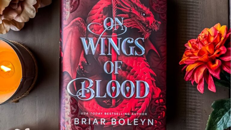 horizontal image of on wings of blood book with flowers and a candle.
