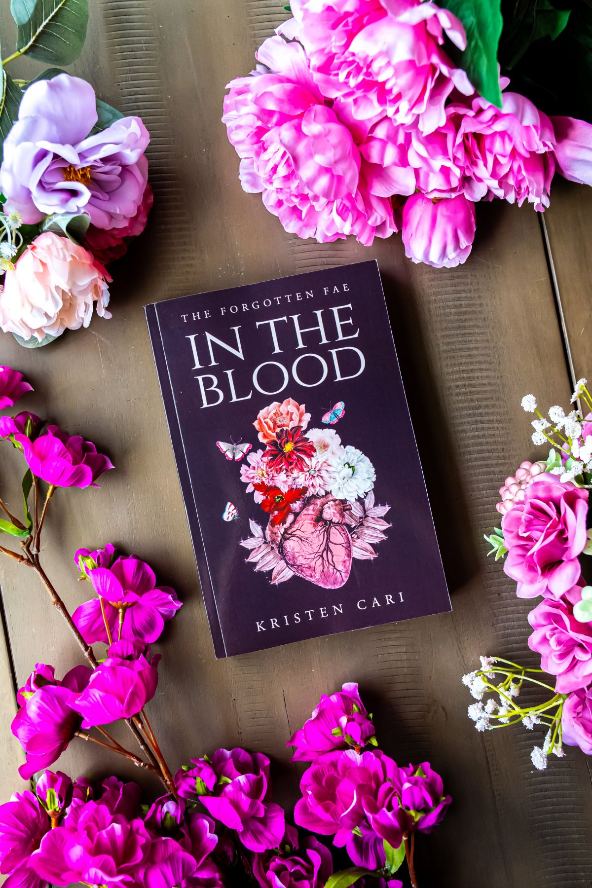 in the blood book flat lay surrounded by flowers