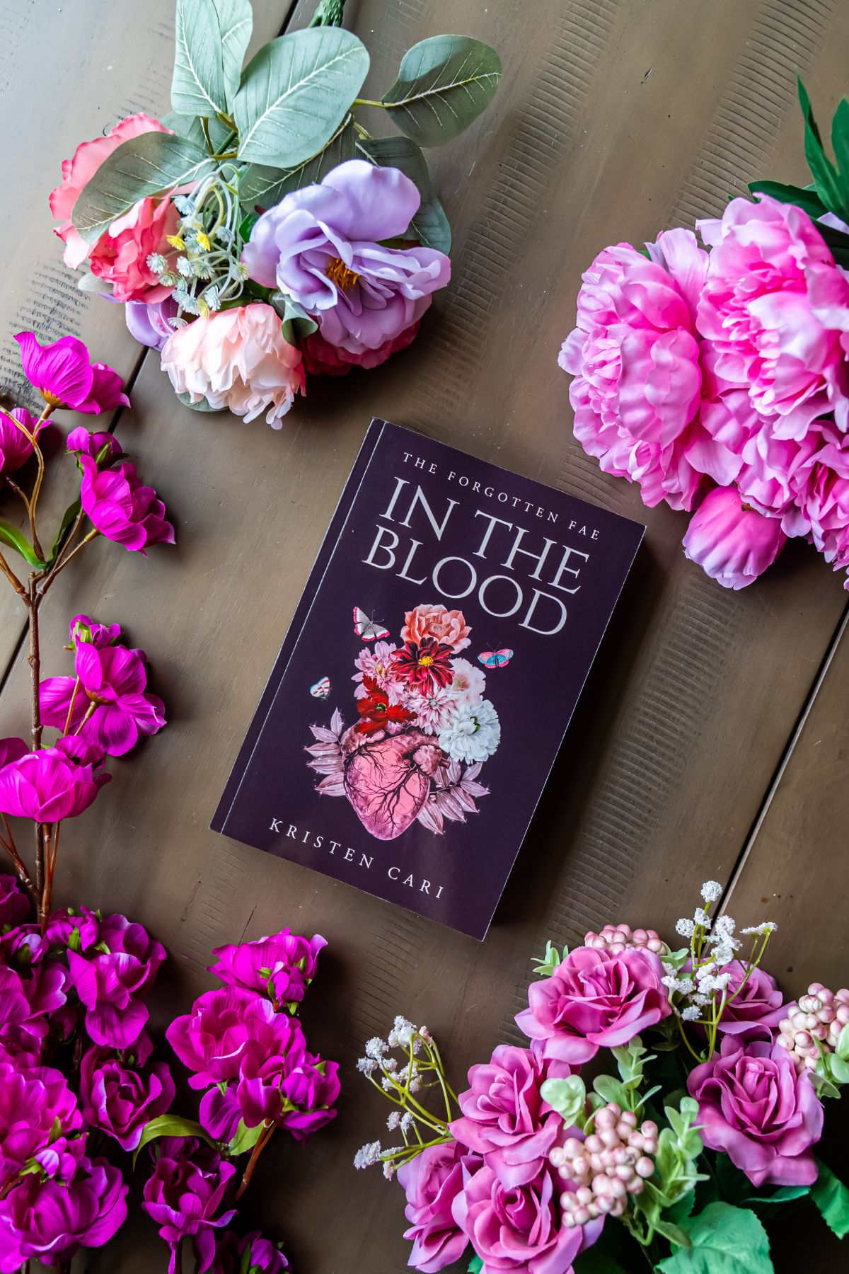 in the blood book flat lay surrounded by flowers