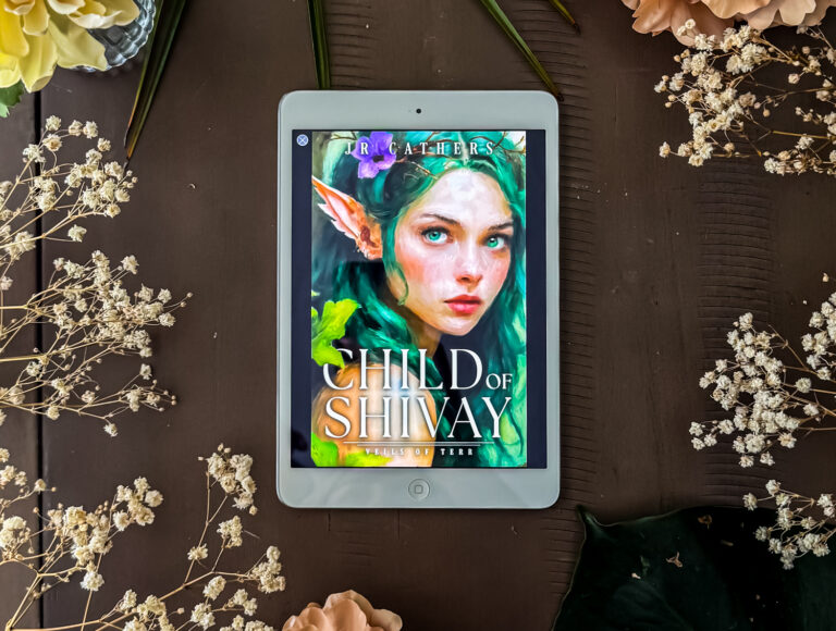 child of shivay book on an iPad surrounded by flowers.