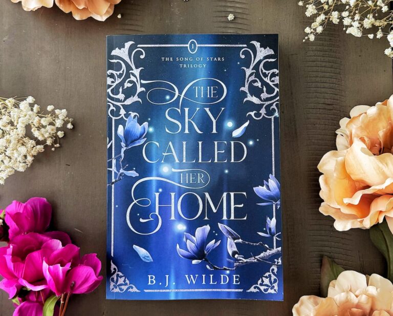 the sky called her home book flay lay with flowers.