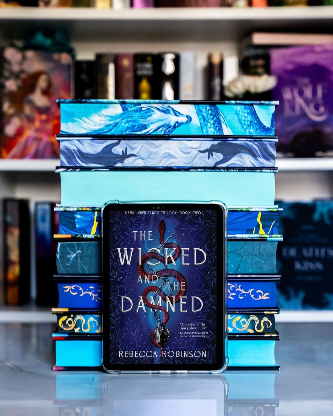 the wicked and the damned on a kindle with blue books.