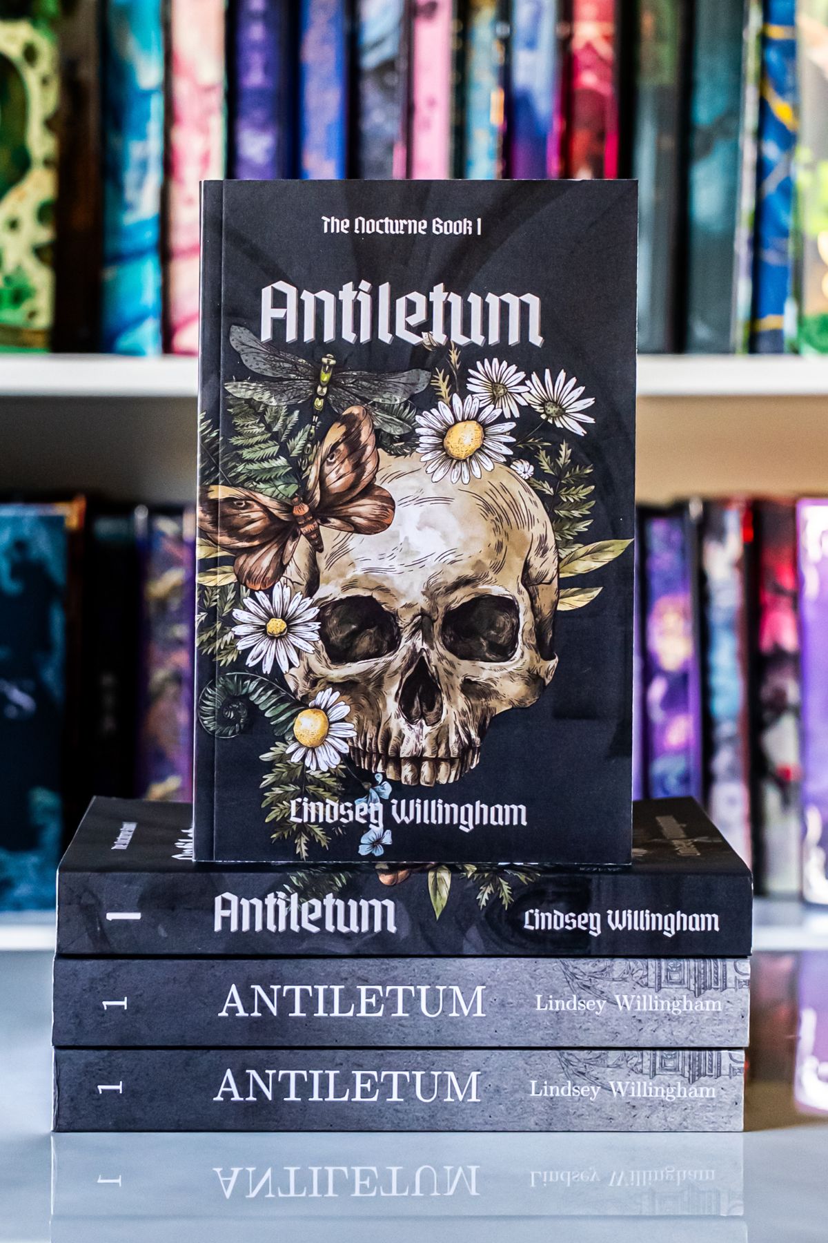 Antiletum book on top of 3 book.