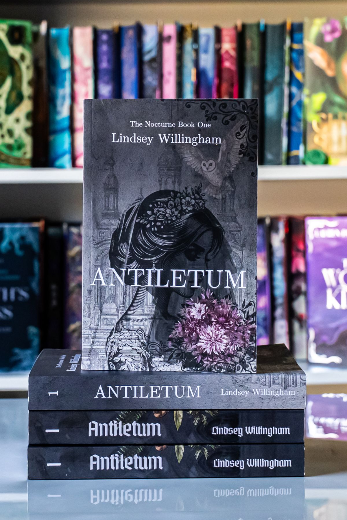 Antiletum book on top of 3 book.