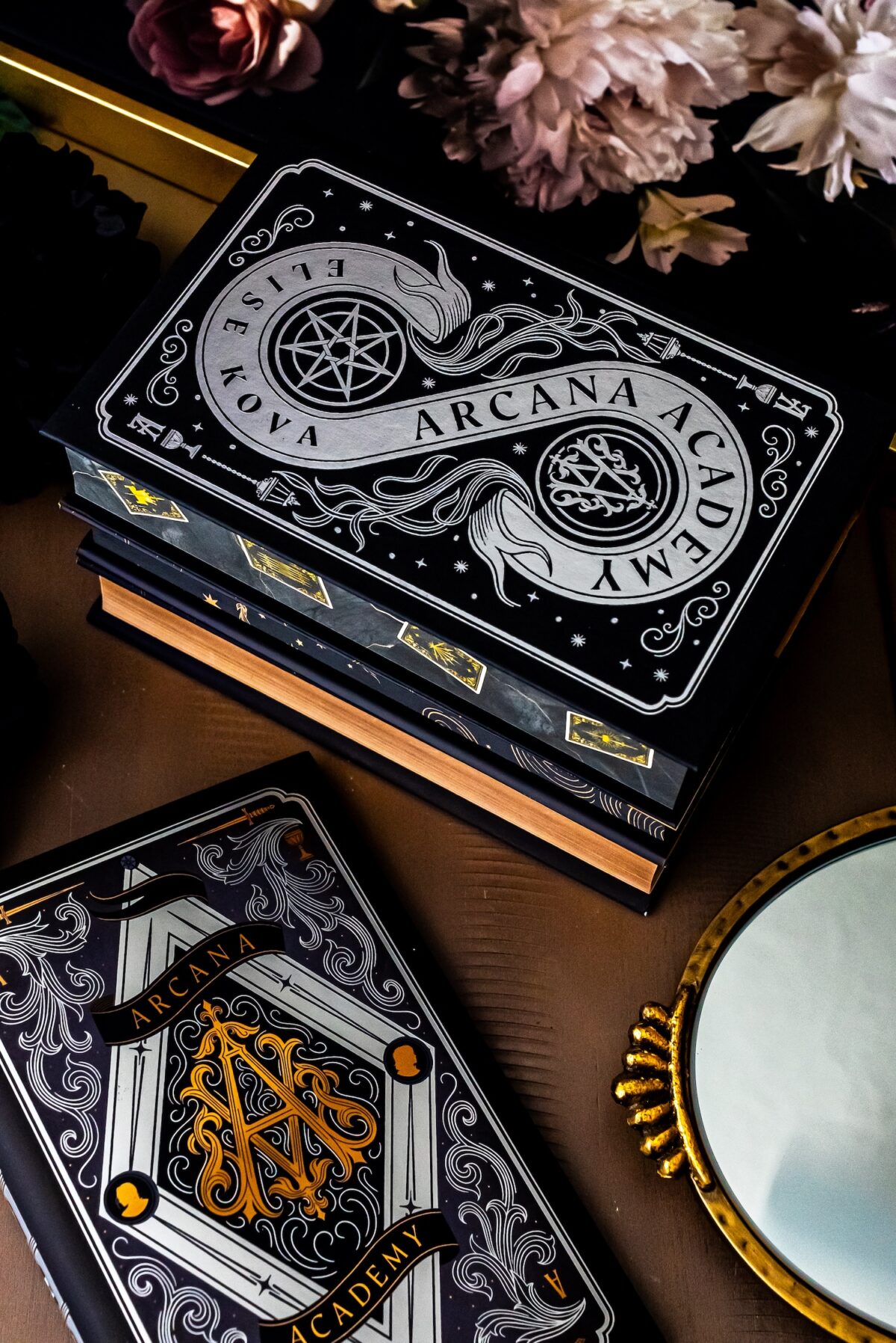 arcana academy book stack.