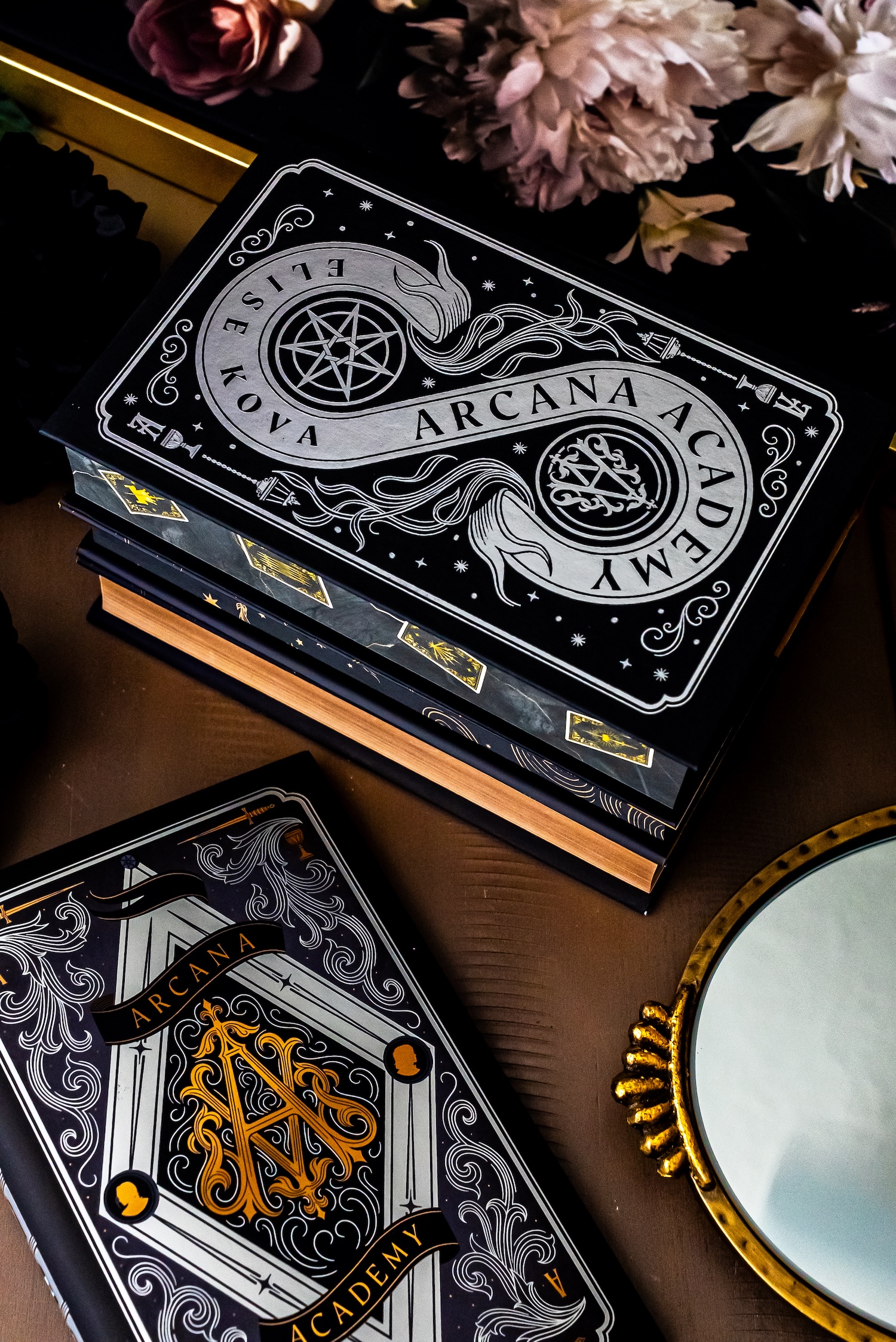 arcana academy book stack.