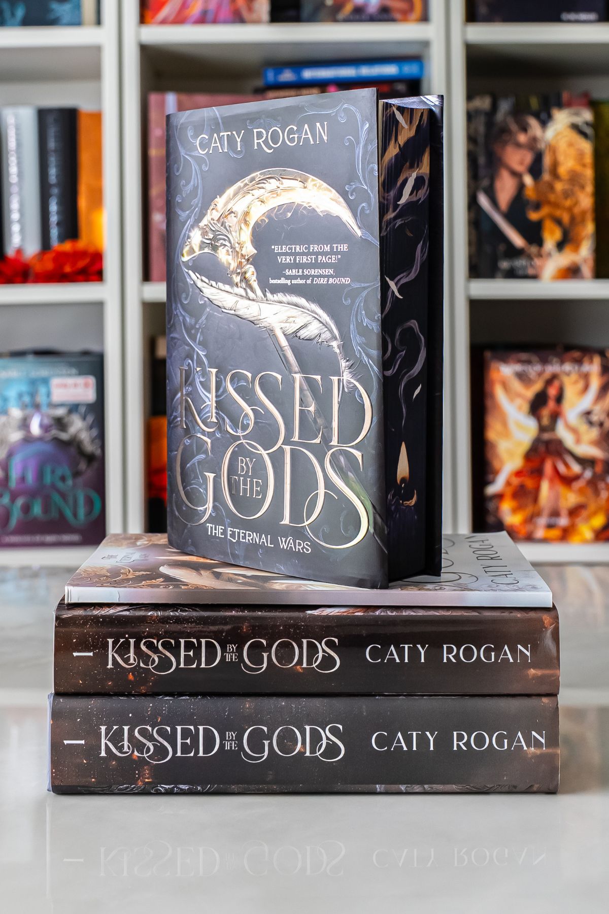 stack of different versions of kidded by the gods